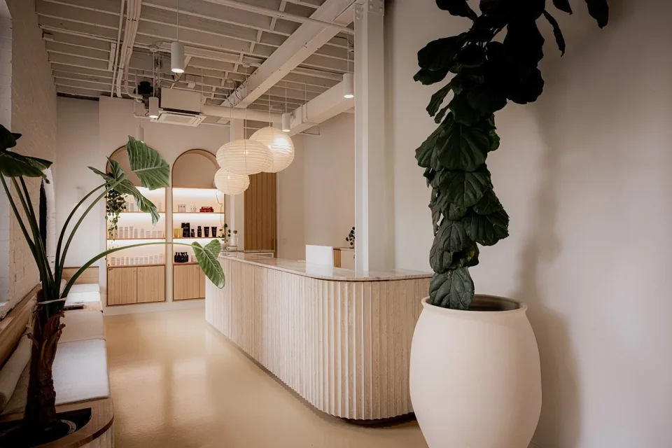 Entrance to Lavada day spa in Hobart with warm colours and shelves with spa products and a reception desk